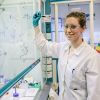 PhD student Emma Cawood writing on a board in a lab at the University of Leeds.