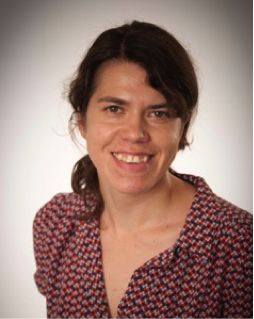 An image of Dr anastasia zhuravleva wearing a red blouse.