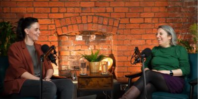 Julie and Amy have a conversation, smiling