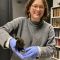Sicily Fiennes holding a museum specimen