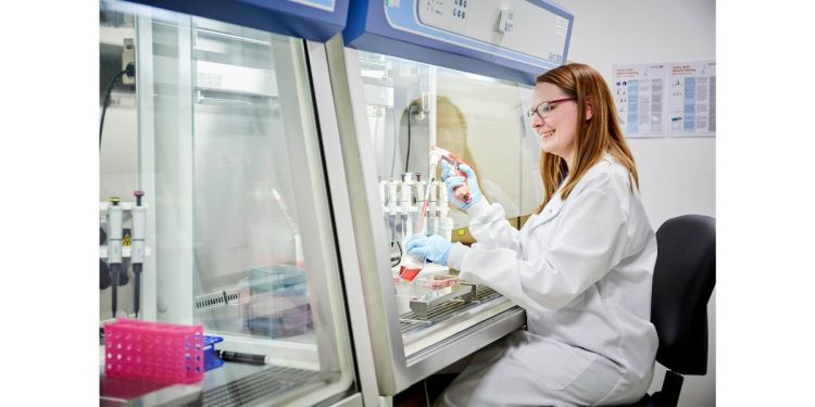 Scientist sat in front of Tissue Culture machine