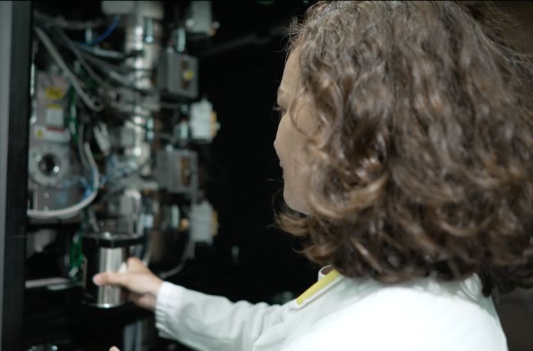 Scientist using electron microscopy equipment